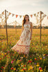 Romantic floral border print midi dress with scalloped neckline, waist tie, and flowing silhouette. Feminine, vintage-inspired, and effortlessly elegant.