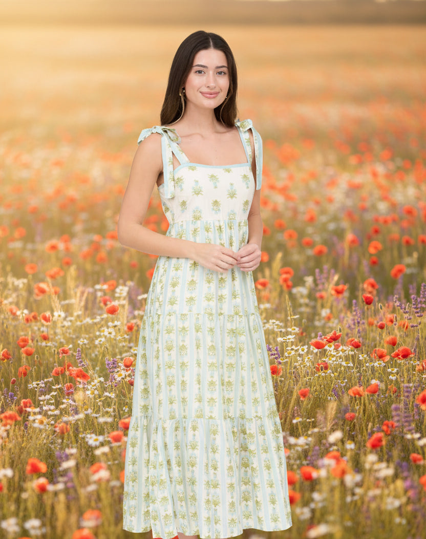 Romantic floral stripe midi dress with tie straps, square neckline, smocked back, and tiered ruffle details. Soft, feminine, and effortlessly elegant.