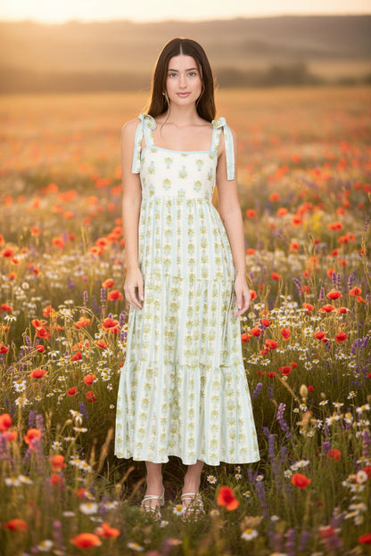 Romantic floral stripe midi dress with tie straps, square neckline, smocked back, and tiered ruffle details. Soft, feminine, and effortlessly elegant.