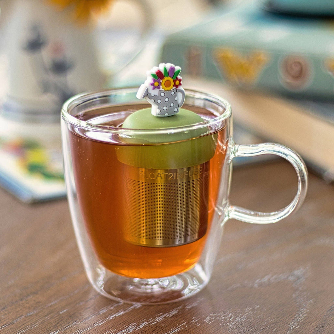 Floral watering can tea infuser with silicone and stainless steel mesh. Reusable, cute, and perfect for loose leaf tea lovers. Fits most mugs.