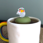 Floral watering can tea infuser with silicone and stainless steel mesh. Reusable, cute, and perfect for loose leaf tea lovers. Fits most mugs.