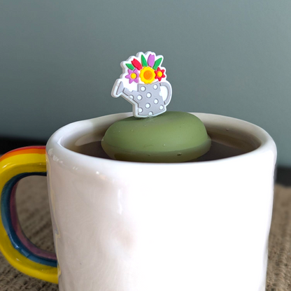 Floral watering can tea infuser with silicone and stainless steel mesh. Reusable, cute, and perfect for loose leaf tea lovers. Fits most mugs.