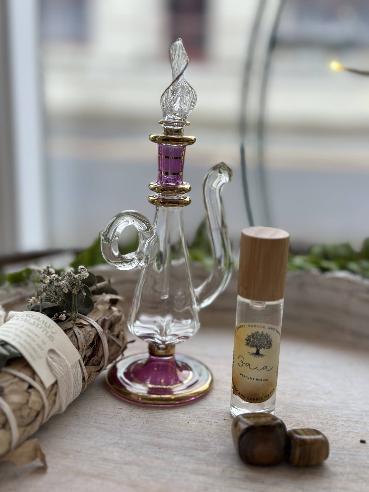 Gaia Goddess Perfume Roller blends sandalwood, vanilla &amp; coconut oil with quartz &amp; copper flakes for a grounding, divine scent. Vegan &amp; hand-poured.