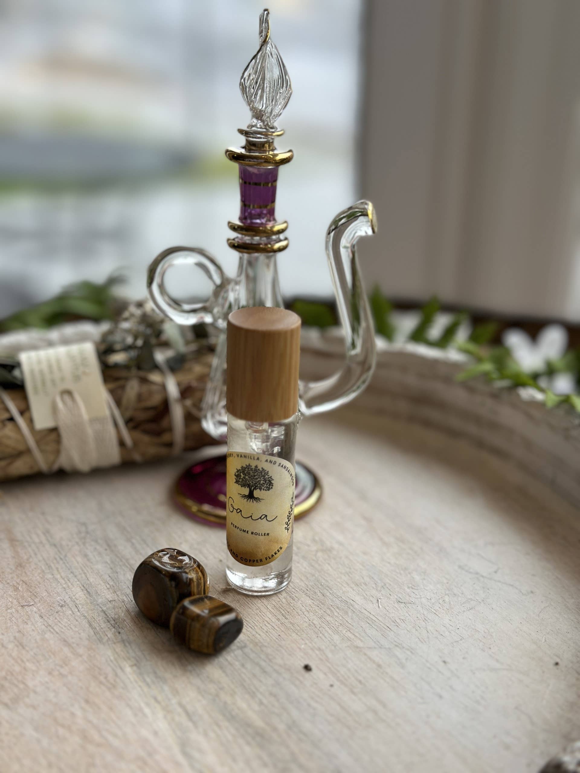 Gaia Goddess Perfume Roller blends sandalwood, vanilla &amp; coconut oil with quartz &amp; copper flakes for a grounding, divine scent. Vegan &amp; hand-poured.