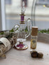 Gaia Goddess Perfume Roller blends sandalwood, vanilla & coconut oil with quartz & copper flakes for a grounding, divine scent. Vegan & hand-poured.