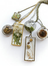 Gathered-in-the-Wild Botanical Necklace with real foraged flowers, mushrooms, pine needles, and leaves preserved in resin. Handcrafted wearable nature art by KStonely.