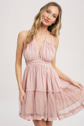 Gauze swing mini dress with halter tie bust, backless design, elastic waist, and mesh ruffle hem. Lightweight summer party dress.