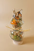 Glass hurricane lantern with a real butterfly, dried autumn flowers, and twigs. A glowing botanical woodland display handcrafted by KStonely.