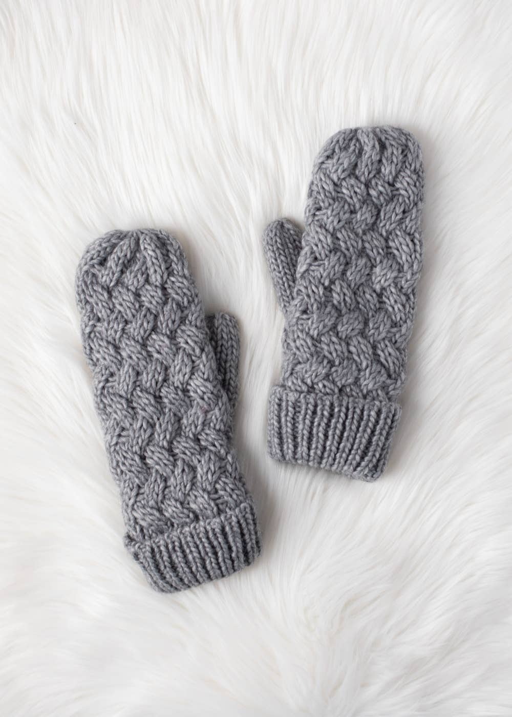Gray knit mittens with cozy fleece lining. Made from 100% acrylic for warmth and durability. A classic winter essential for everyday cold-weather comfort.