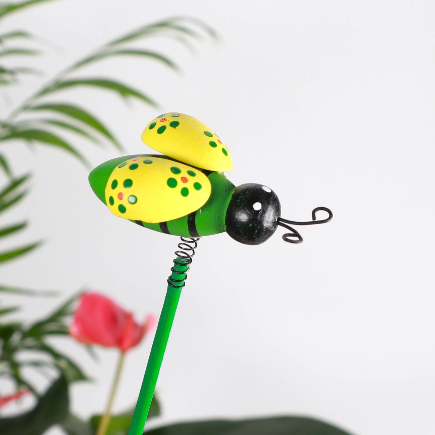 Whimsical bee plant picks with wooden bees on springs. Adds playful movement to houseplants and gardens. Adjustable 19" stake. No plants included.