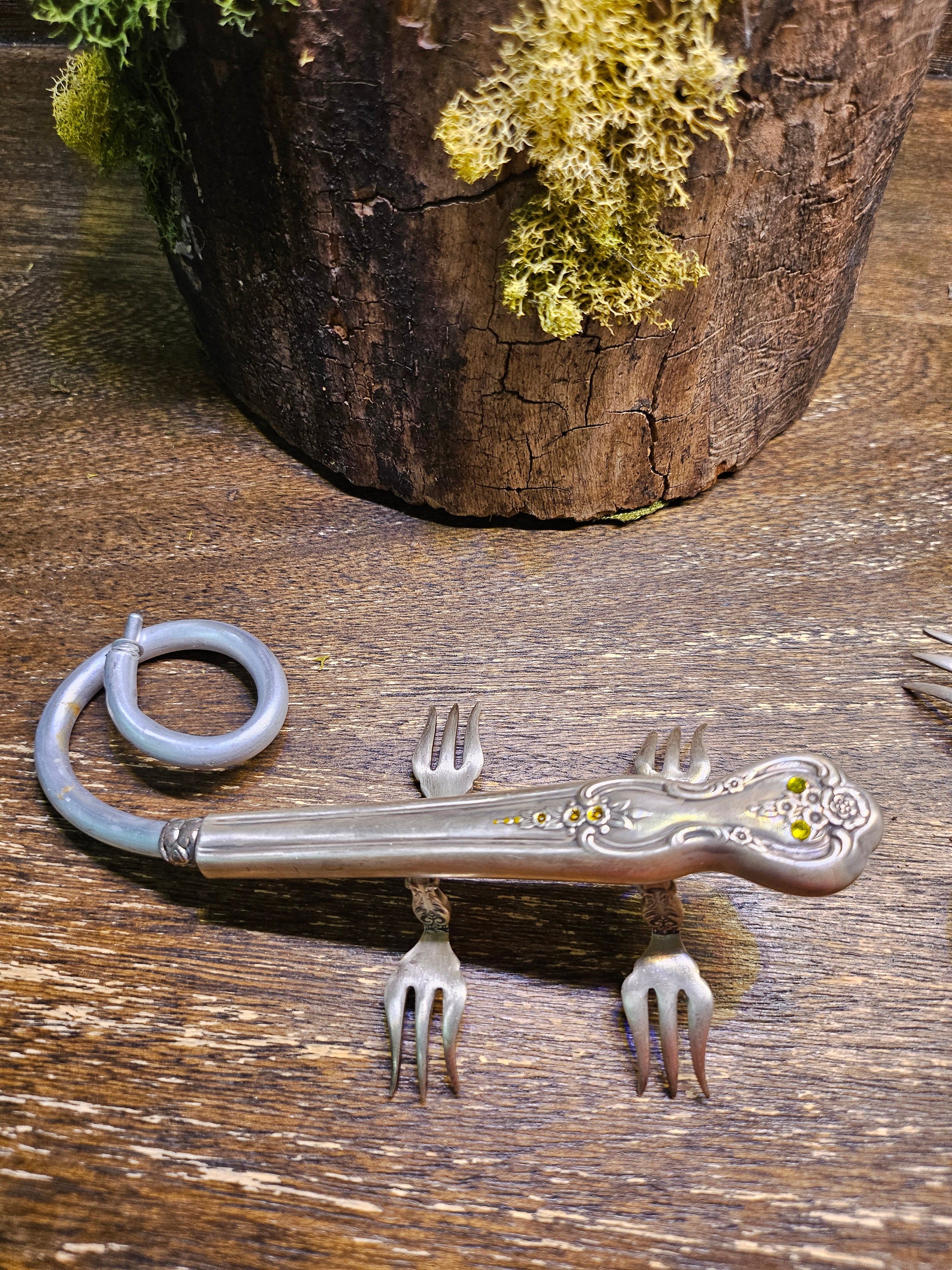 Handcrafted lizard sculpture made from vintage silverware. A whimsical, one-of-a-kind art piece symbolizing luck, renewal, and sun-loving charm.