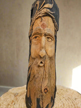 This 14" Hand-Carved Wood Spirit in solid walnut features intricate details and black-painted accents. 100% handmade, each piece is unique and perfect for home decor. The natural walnut grain and artisanal craftsmanship add rustic charm, making it a standout decorative piece for any space.