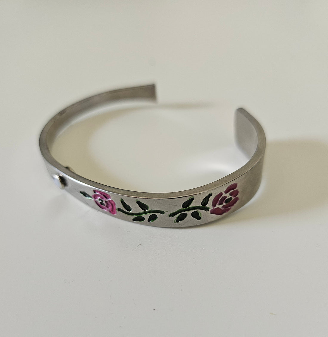 Handcrafted 6" floral cuff bracelet made from vintage silverware with a jewel accent. A one-of-a-kind piece blending antique charm and timeless elegance.