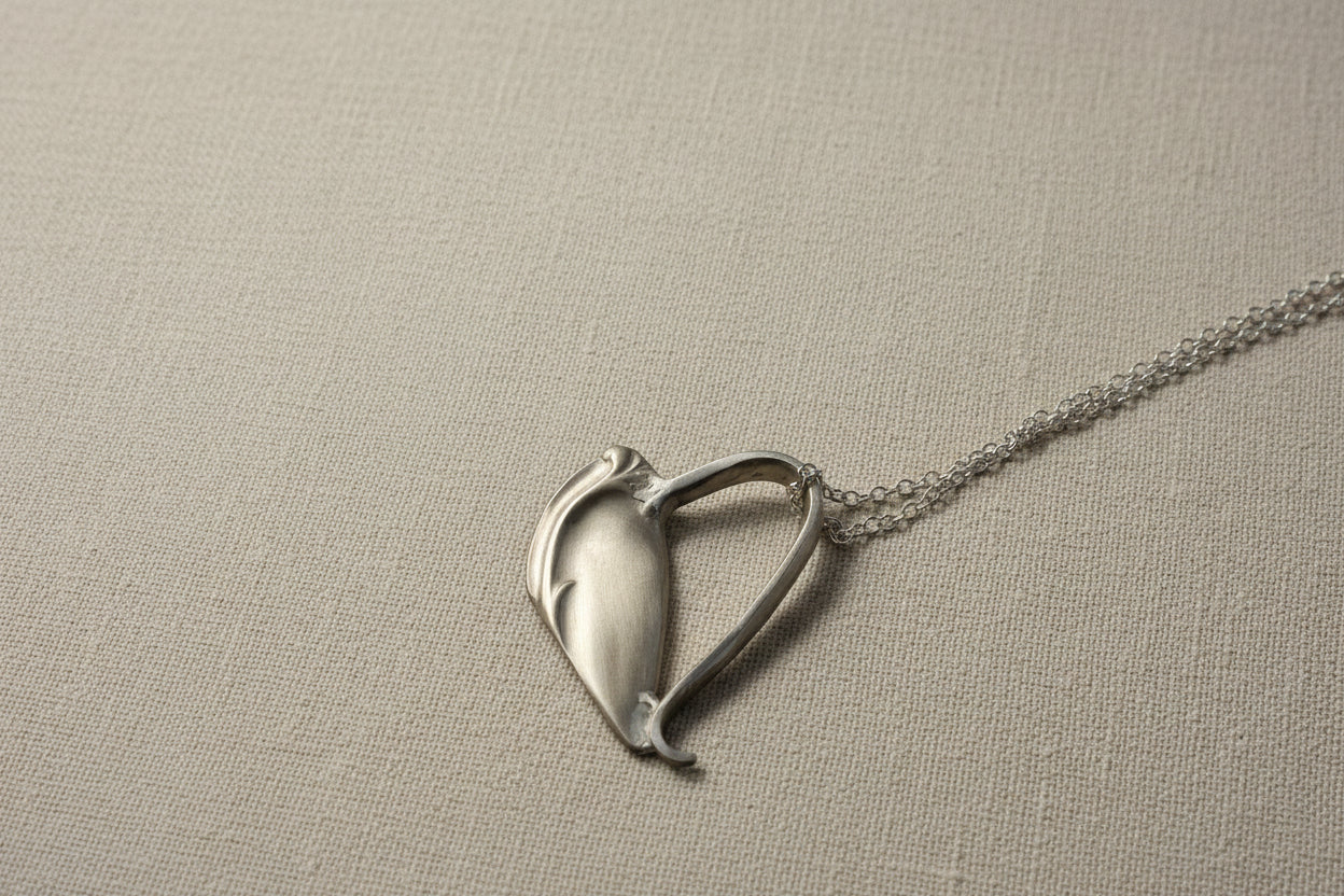 Handcrafted heart pendant made from vintage silverware. A unique, eco-friendly symbol of love—artisan-made in the USA and perfect for gifting or everyday wear.