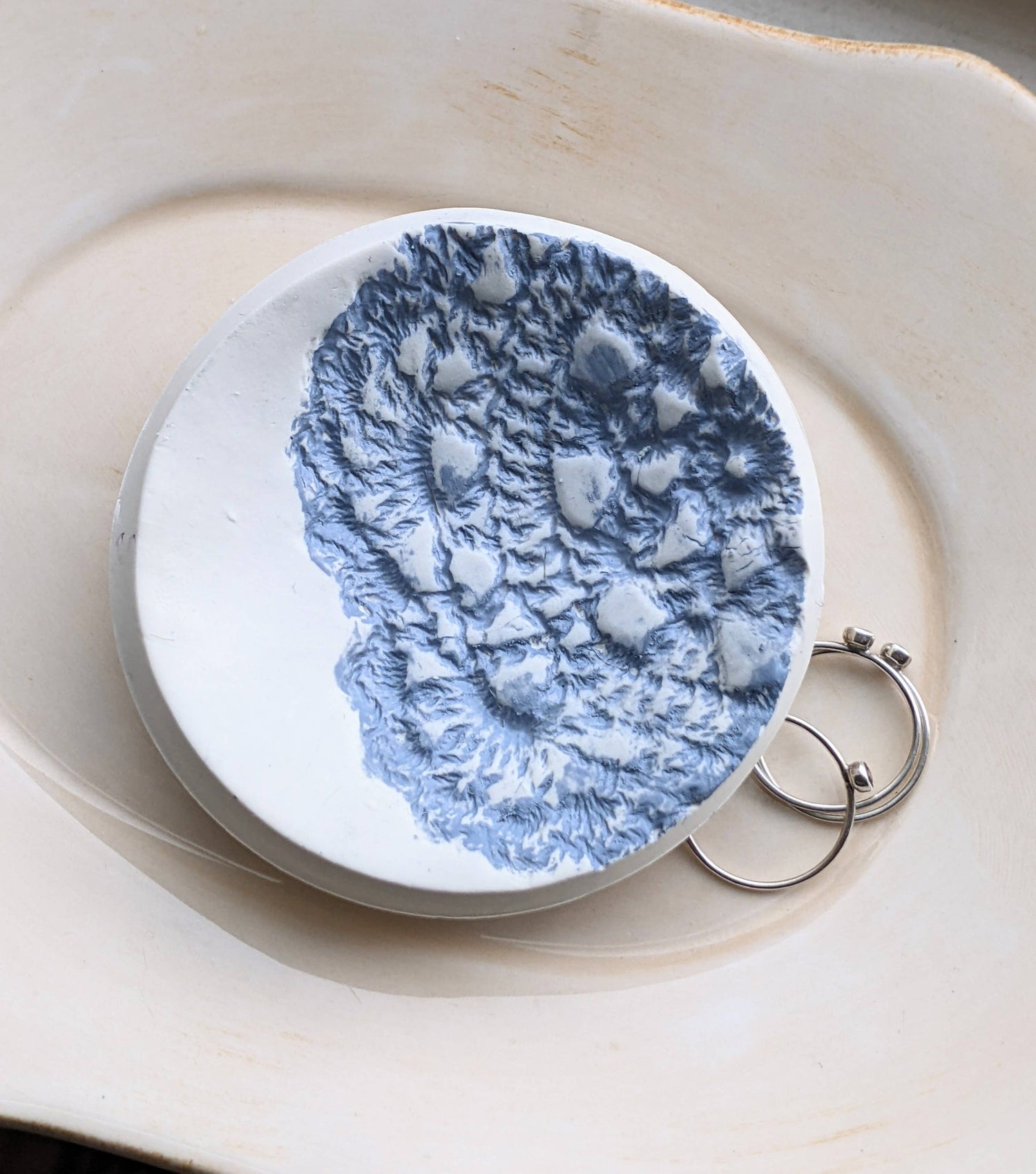 Handmade polymer clay dish with a green lace impression. Perfect as a jewelry or ring holder. Durable, decorative, and one-of-a-kind. Not food safe.