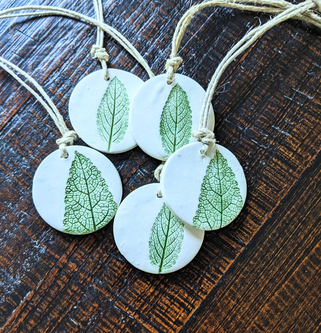 Handmade polymer clay ornaments with real leaf impressions and hand-painted detail. Unique, nature-inspired décor for trees, gifts, or year-round charm.