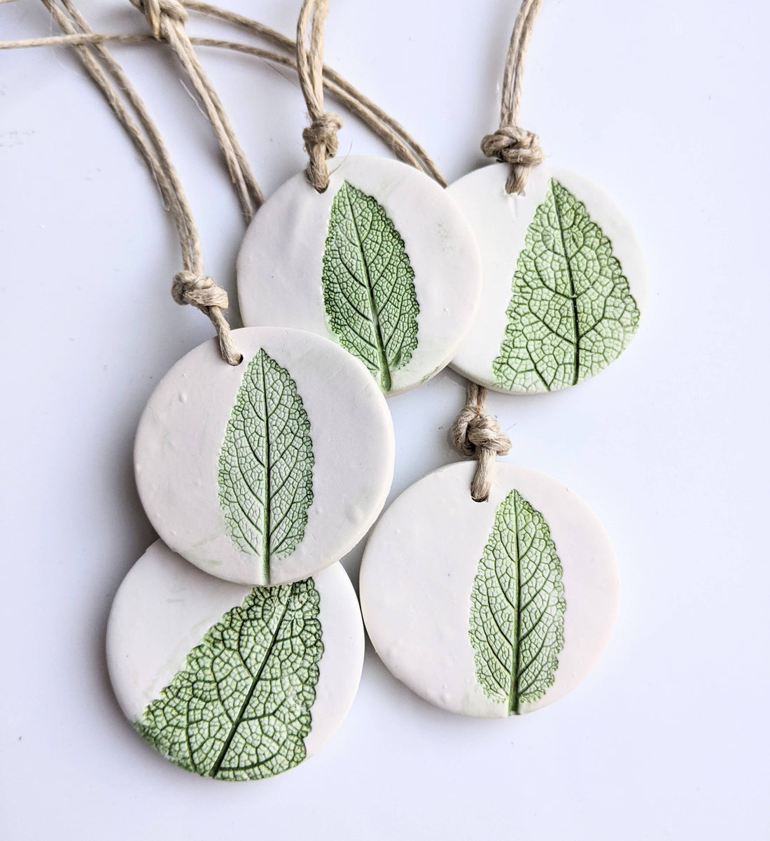 Handmade polymer clay ornaments with real leaf impressions and hand-painted detail. Unique, nature-inspired décor for trees, gifts, or year-round charm.