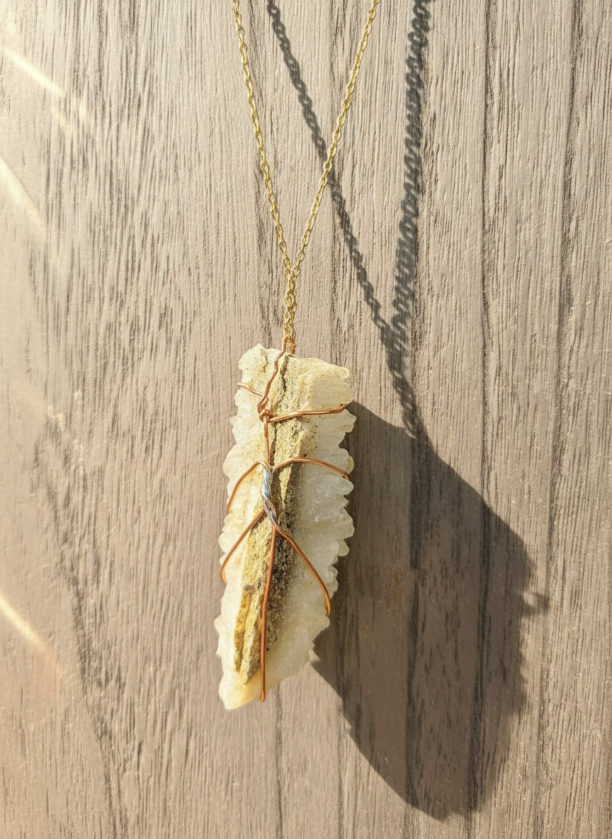 Handmade copper wire-wrapped crystal necklace by Kstonely. Features a 3&quot; x 1&quot; pendant on a gold chain—rustic, elegant, and perfect for boho jewelry lovers.