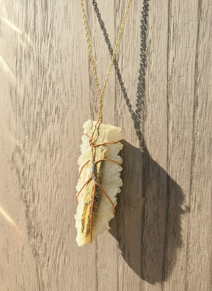 Handmade copper wire-wrapped crystal necklace by Kstonely. Features a 3&quot; x 1&quot; pendant on a gold chain—rustic, elegant, and perfect for boho jewelry lovers.