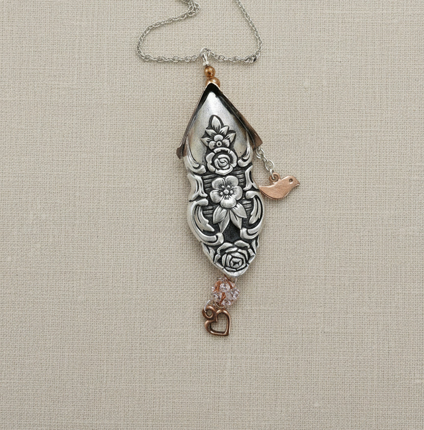 Handcrafted silver birdhouse pendant made from vintage silverware. A whimsical, one-of-a-kind necklace perfect for nature lovers and vintage jewelry fans.