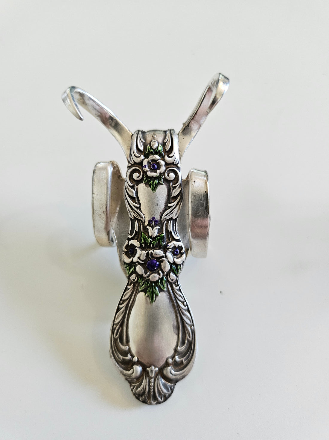 The Lucky Fork Cricket is a handcrafted sculpture made from repurposed vintage silverware, blending artistry with charm. Inspired by crickets—symbols of luck and prosperity—each piece is unique, adorned with jewels and aged patina. A perfect collectible or gift, this whimsical creation brings history, elegance, and positive energy to any space.