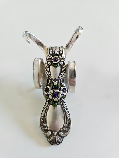 The Lucky Fork Cricket is a handcrafted sculpture made from repurposed vintage silverware, blending artistry with charm. Inspired by crickets—symbols of luck and prosperity—each piece is unique, adorned with jewels and aged patina. A perfect collectible or gift, this whimsical creation brings history, elegance, and positive energy to any space. 