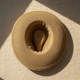 Braided cord band cowboy hat featuring woven paper straw texture and soft curved brim. Lightweight boho western style perfect for beach days, festivals, and summer outfits.