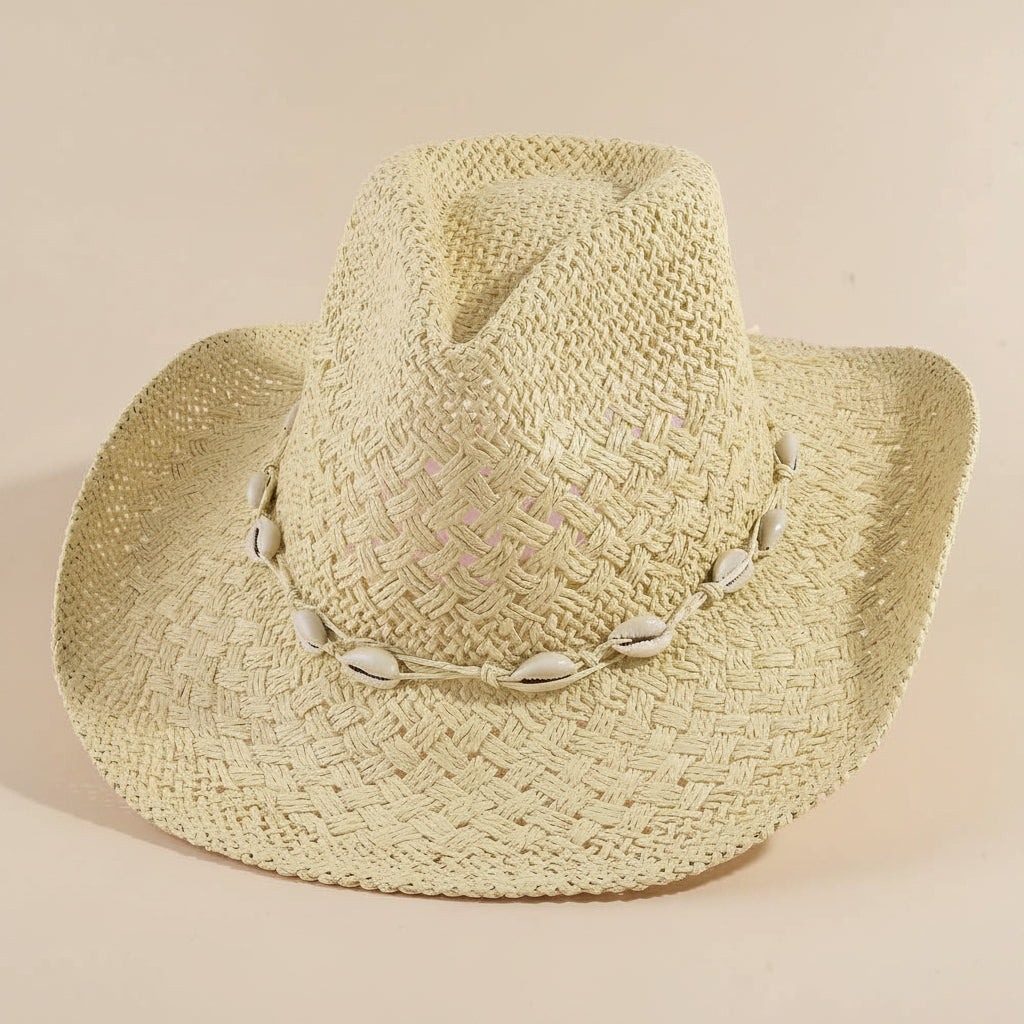 Cowrie Shell Band Cowboy Hat featuring woven paper straw texture and coastal boho western style. Lightweight, breathable, and perfect for beach days or festivals.