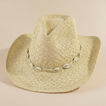 Cowrie Shell Band Cowboy Hat featuring woven paper straw texture and coastal boho western style. Lightweight, breathable, and perfect for beach days or festivals.