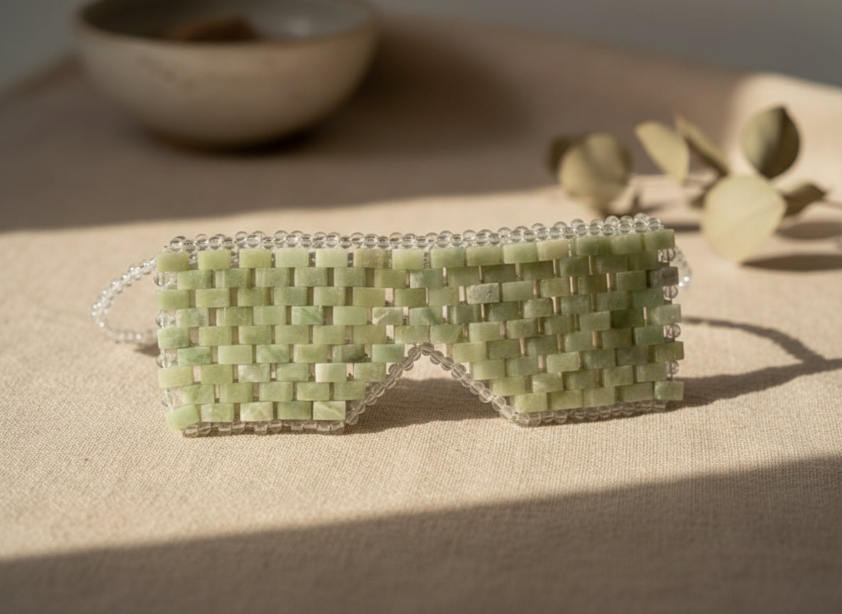 Cooling or warming jade eye mask made from 100% real jade beads. Reduces puffiness, soothes tension, boosts circulation, and brings calm, balance, and radiant renewal.