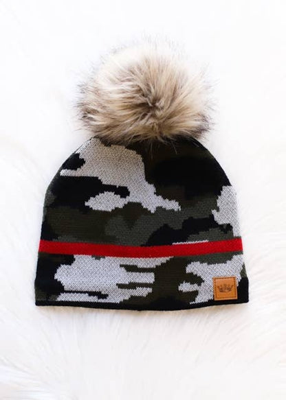 Green camo knit pom hat with bold red stripe detail, a natural-toned faux fur pom and cozy fleece lining. A playful winter accessory for chilly days.