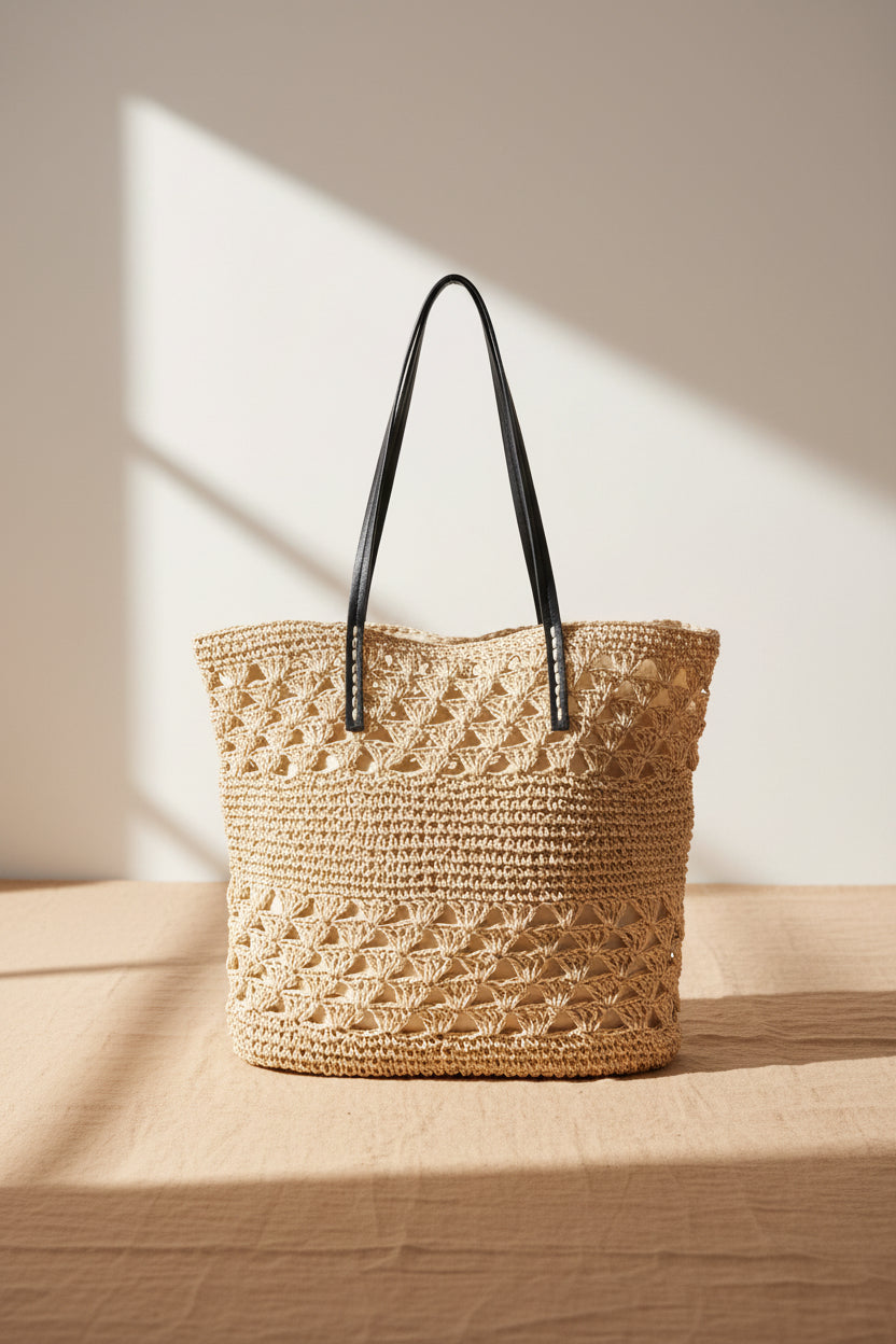 Knitted tote bag with vegan leather handles featuring a spacious woven design and timeless neutral style. Perfect for everyday wear, travel, shopping, and beach outings.