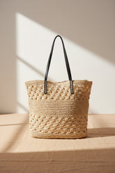 Knitted tote bag with vegan leather handles featuring a spacious woven design and timeless neutral style. Perfect for everyday wear, travel, shopping, and beach outings.