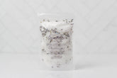 Handcrafted 5 oz botanical bath salts in heat-sealed pouches. Plant-based, aromatic blends with essential oils & florals for a calming, skin-softening soak.