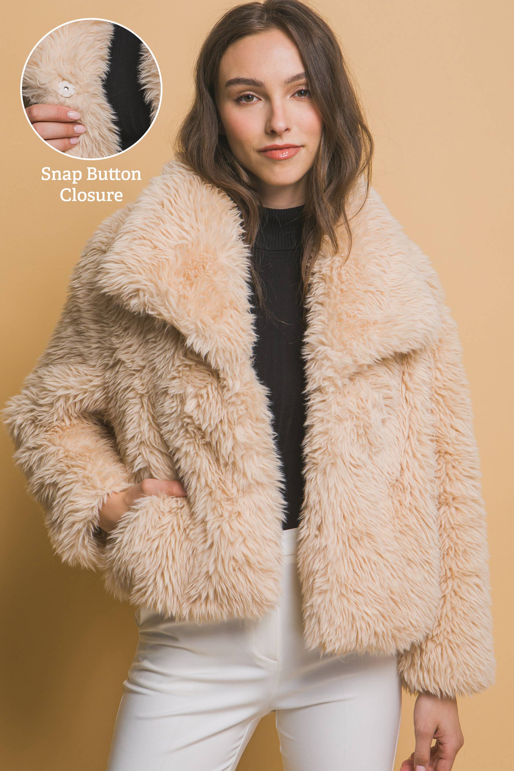 Mid-waist faux fur coat with snap button closure and side pockets. Soft 100% polyester for cozy warmth and chic style—perfect for day or night looks.