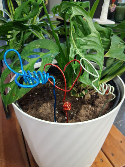Decorative mini wire and marble plant stakes bring artistic charm to houseplants, terrariums, and plant shelves. Handcrafted botanical accents.