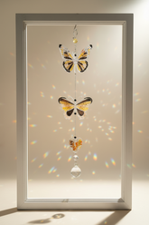 Handmade butterfly suncatchers with real pressed flowers and crystal chain. Reflects sunlight into rainbows—perfect for windows or near plants.