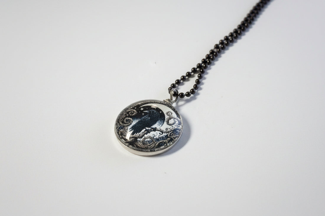 Handcrafted nature scene necklaces with real botanicals in iridescent and clear resin. Unique, wearable landscapes on chain or satin cord.