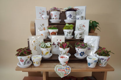 Mother’s Day gift set with live plant, floral terra cotta pot, soy coconut candle, and pressed flower card. Handcrafted, botanical, and ready to gift.