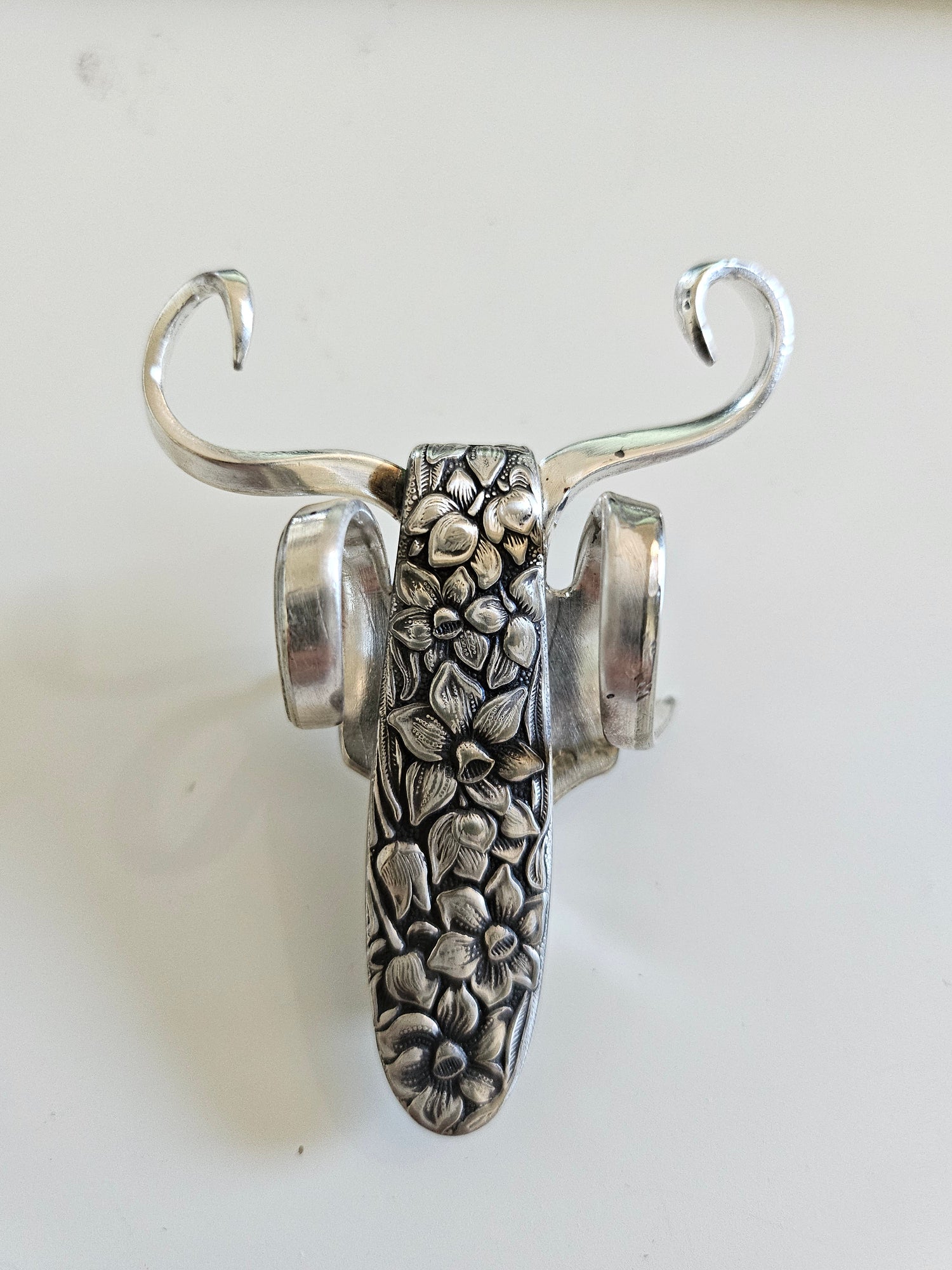 The Lucky Fork Cricket is a handcrafted sculpture made from repurposed vintage silverware, blending artistry with charm. Inspired by crickets—symbols of luck and prosperity—each piece is unique, adorned with jewels and aged patina. A perfect collectible or gift, this whimsical creation brings history, elegance, and positive energy to any space. 