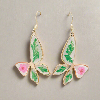 Narcissus &amp; Ferns Butterfly Earrings with real pressed flowers in resin and gold-tone metal. Lightweight, nature-inspired statement jewelry for any occasion.