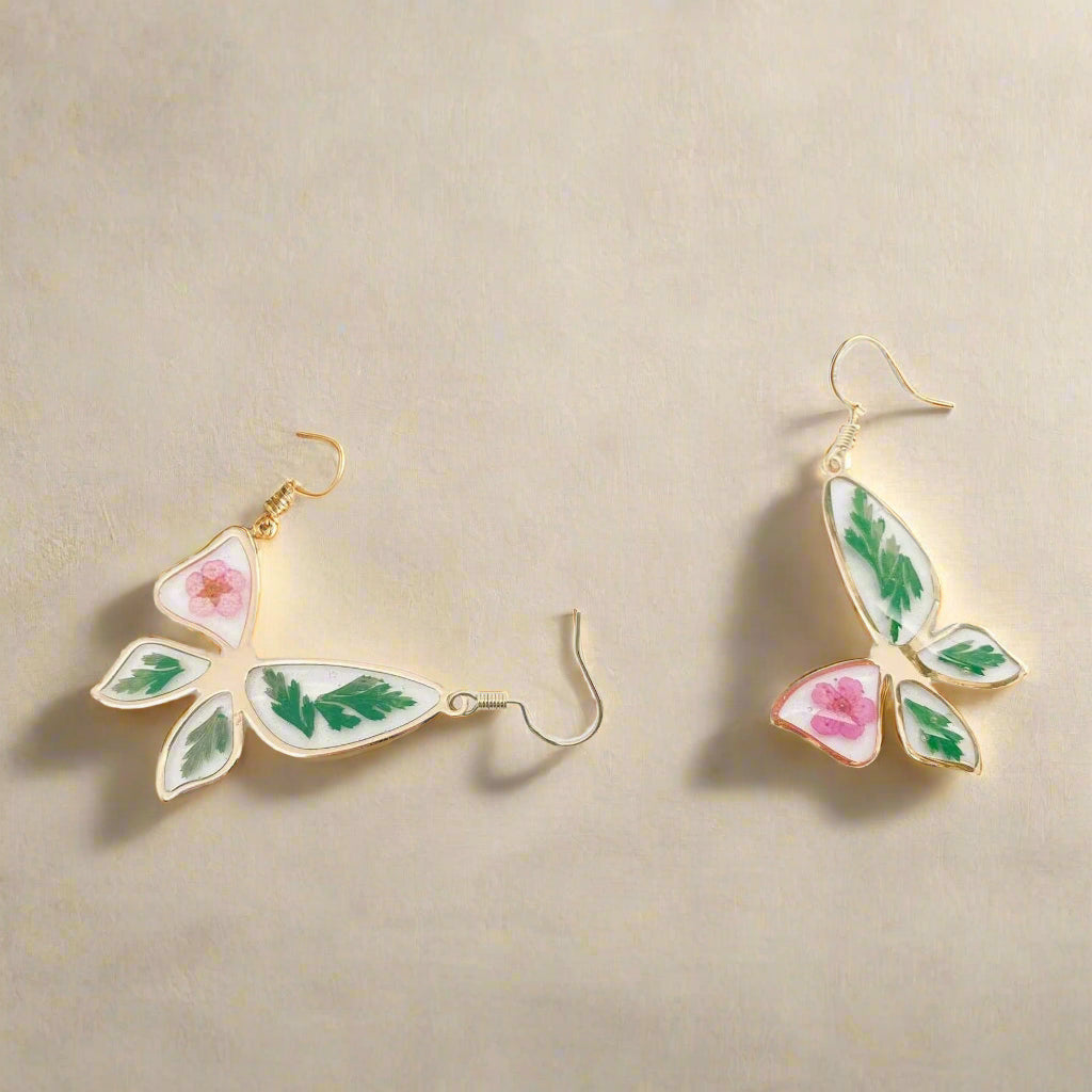 Narcissus & Ferns Butterfly Earrings with real pressed flowers in resin and gold-tone metal. Lightweight, nature-inspired statement jewelry for any occasion.