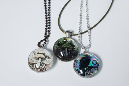 Handcrafted nature scene necklaces with real botanicals in iridescent and clear resin. Unique, wearable landscapes on chain or satin cord.