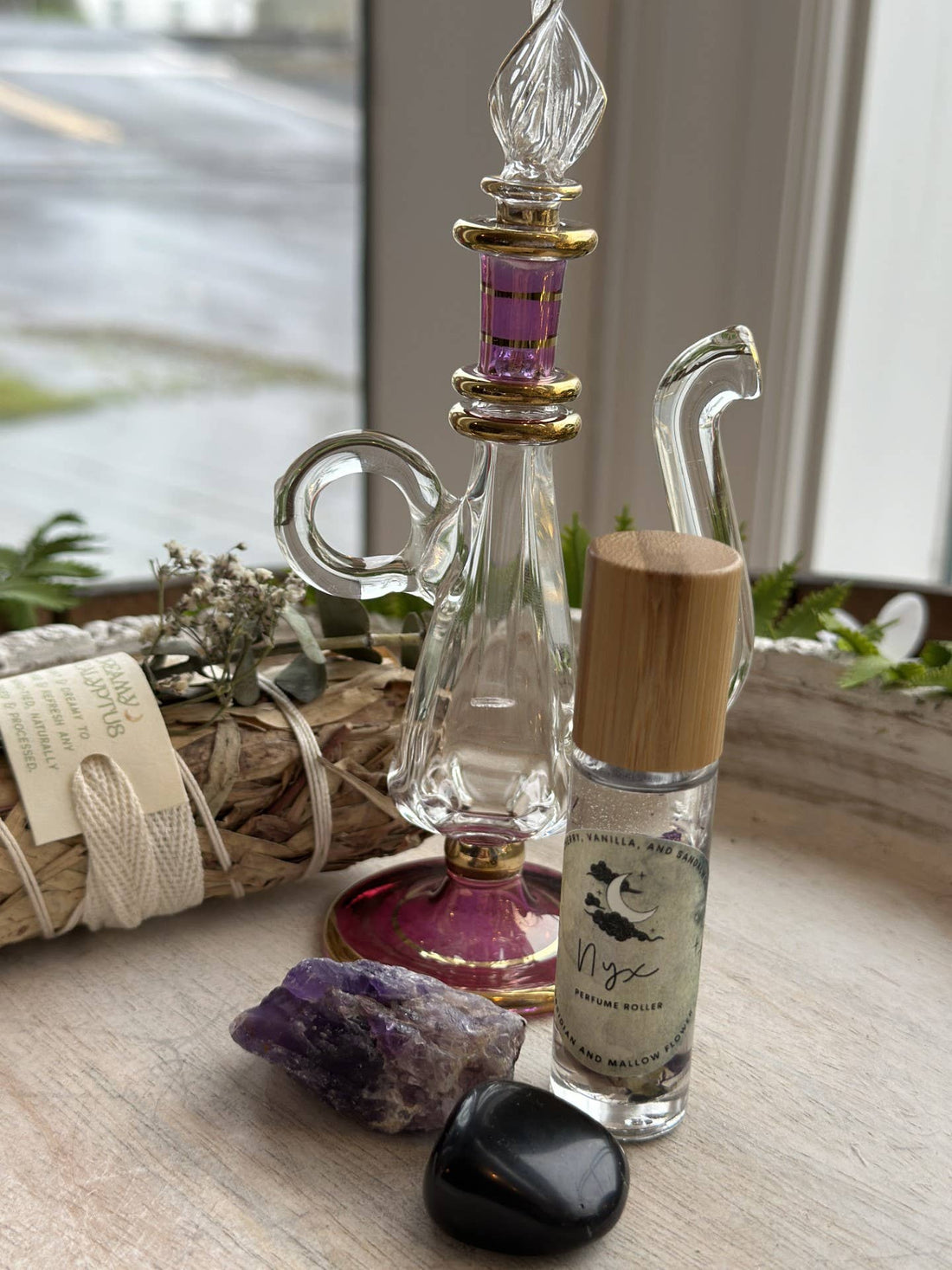 Nyx Goddess Perfume Roller with coconut oil, black obsidian &amp; mallow flower. Oriental and almond notes create a mystical, night-inspired aura.