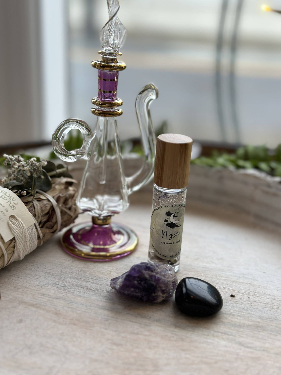 Nyx Goddess Perfume Roller with coconut oil, black obsidian &amp; mallow flower. Oriental and almond notes create a mystical, night-inspired aura.