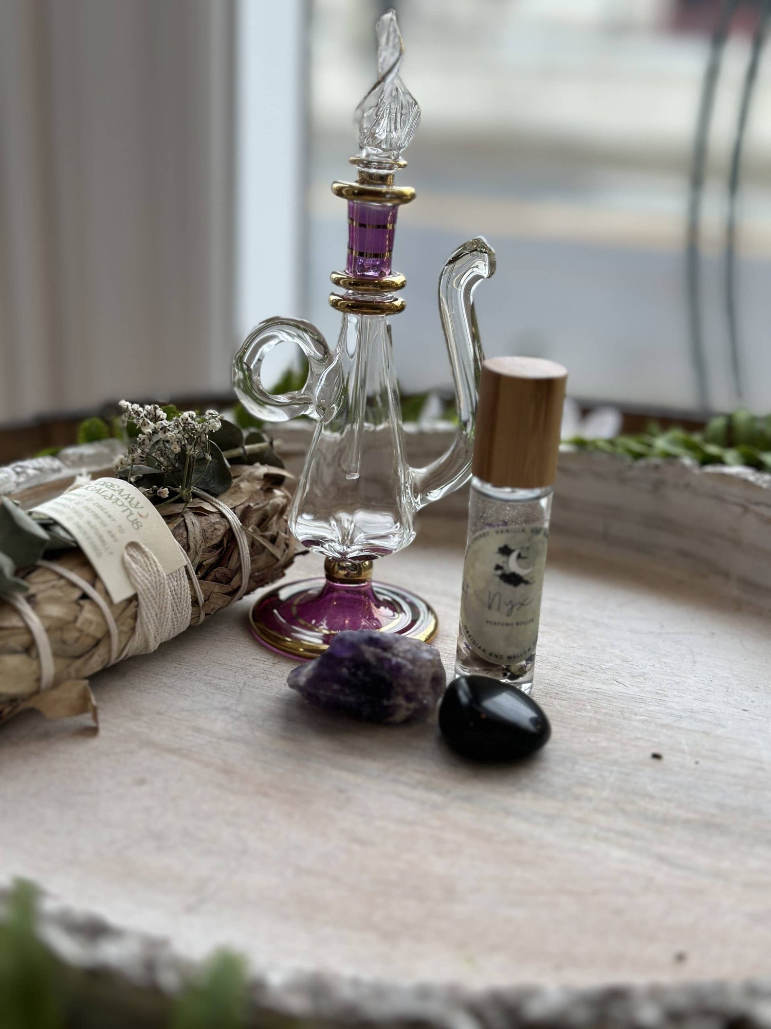 Nyx Goddess Perfume Roller with coconut oil, black obsidian &amp; mallow flower. Oriental and almond notes create a mystical, night-inspired aura.