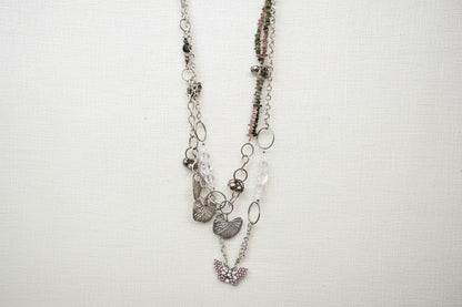 Pink Butterfly Curated Chaos Layered Charm Necklace handcrafted by artist KStonely with chains, ribbon, beads, and unique charms. One-of-a-kind mixed-media wearable art jewelry.