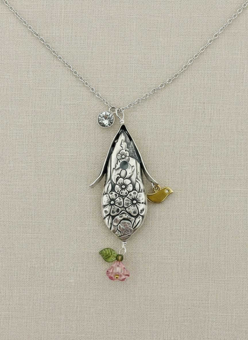 Handcrafted silver birdhouse pendant made from vintage silverware. A whimsical, one-of-a-kind necklace perfect for nature lovers and vintage jewelry fans.