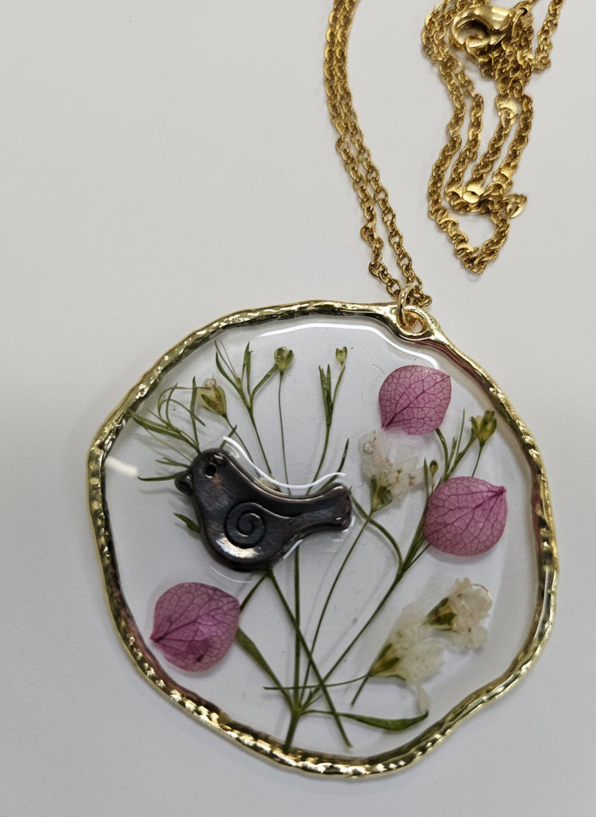 Birdsong Botanical Necklace featuring real preserved flowers and botanicals in resin. A handcrafted, nature-inspired keepsake for bird and plant lovers.