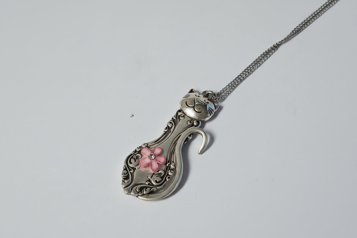 Handmade silver cat pendant necklaces from vintage silverware. Elegant, whimsical, and adjustable on a satin cord. Sustainably crafted and one-of-a-kind.